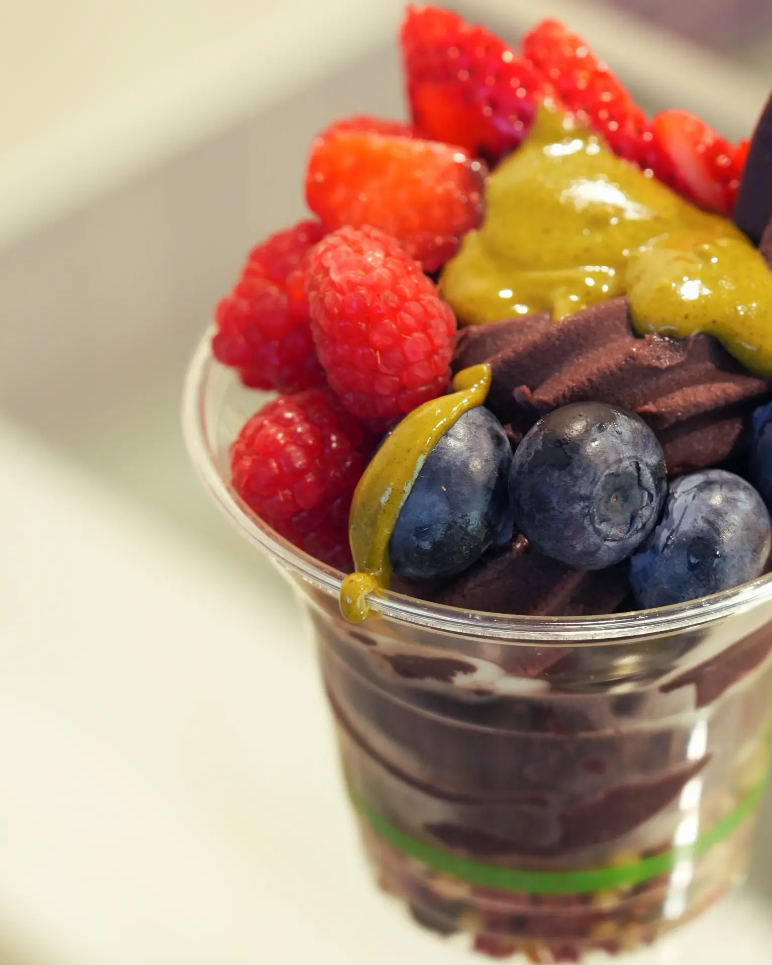 Acai bowl topped with raspberries, blueberries and house-made pistachio butter